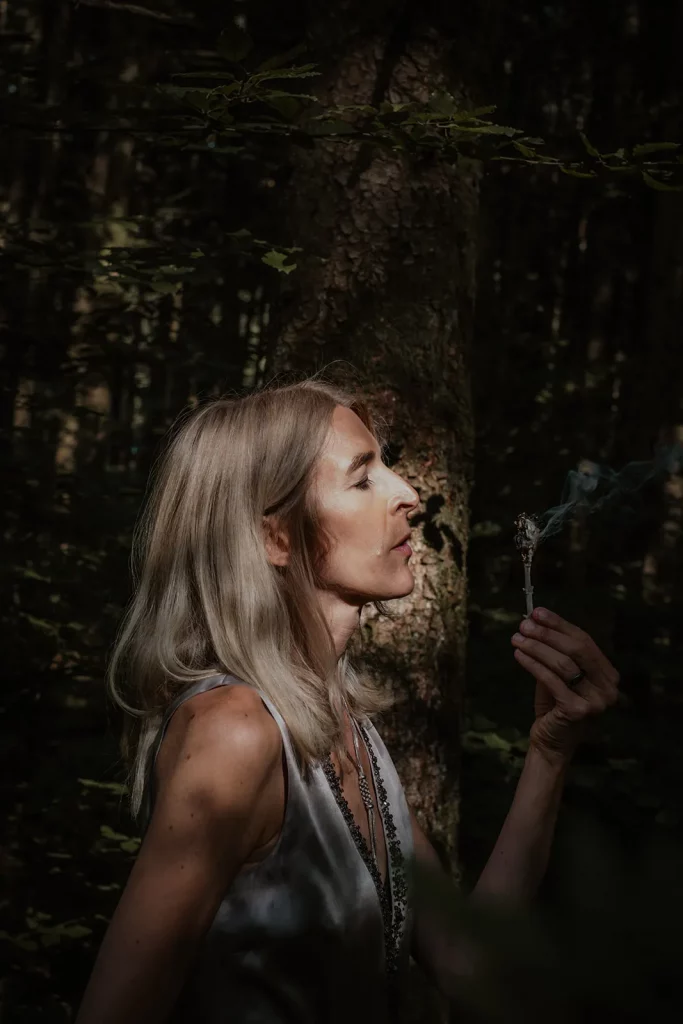 Maja Keppler mit einem Breathwork-Ritualgegenstand im Wald